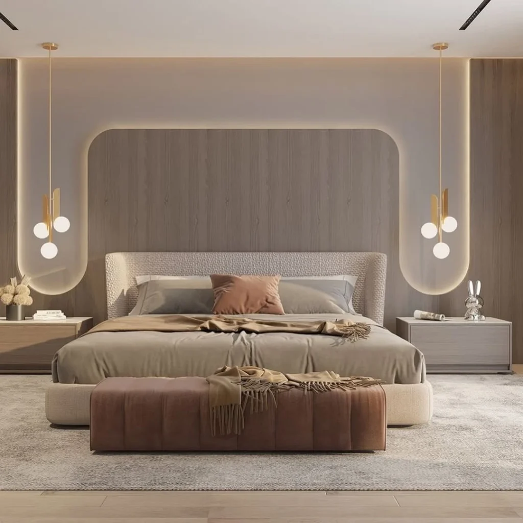 Modern luxury bedroom with beige tones, marble accent wall, and soft upholstered bed design