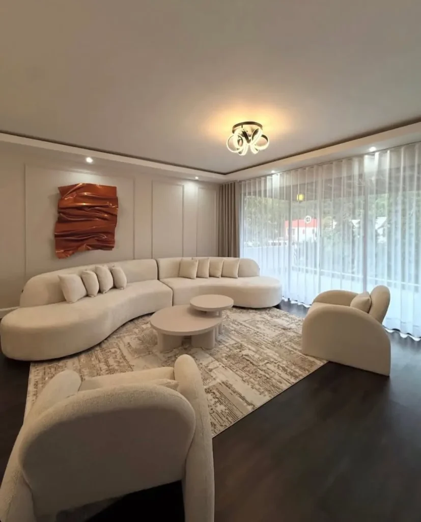 Stylish living room furniture with brown leather sectional, modern coffee table, and textured wall design