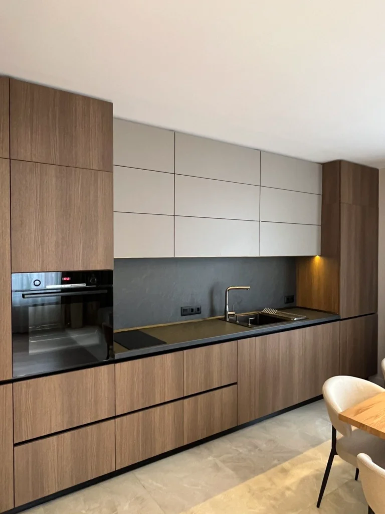 Modern kitchen design with wooden cabinets, sleek countertop, and minimalist layout