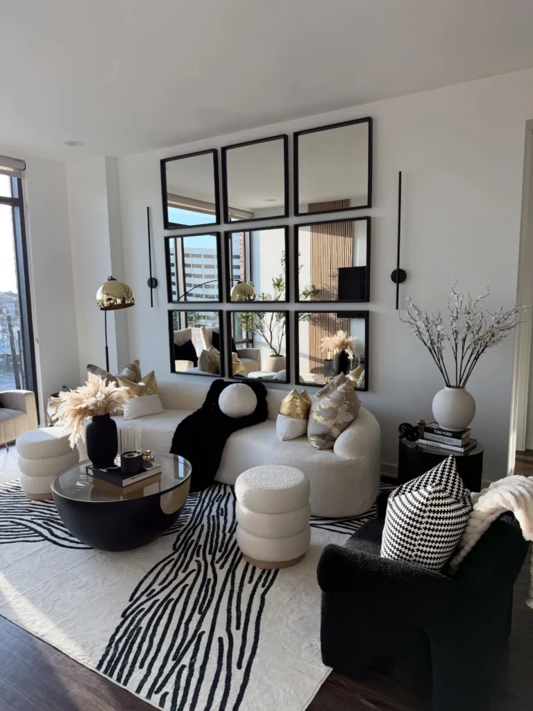 Modern glam living room with mirror wall, plush seating, and stylish decor