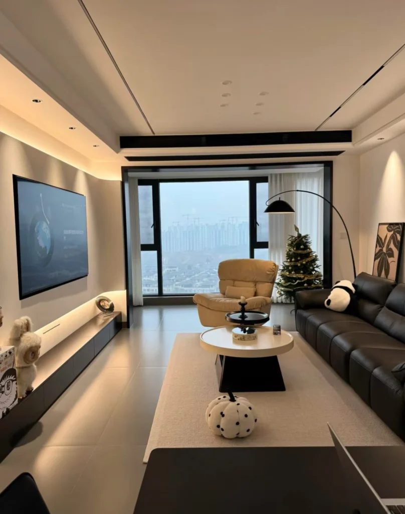 Modern TV living room with wall-mounted television, sectional sofa, and ambient lighting