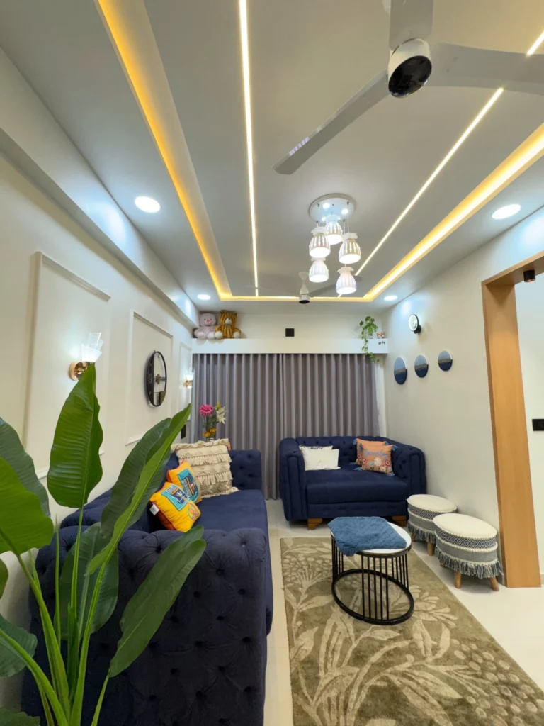 Small cozy living room with blue sofas, compact layout, and warm lighting