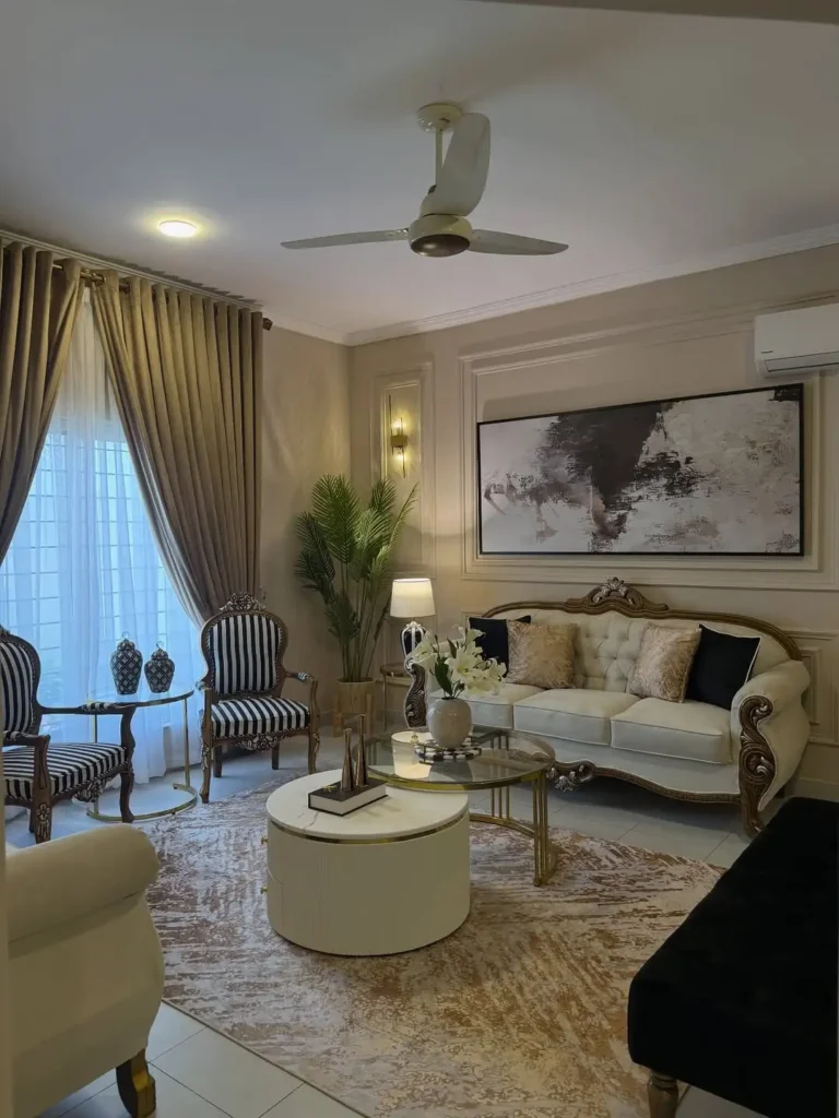 Modern luxury drawing room with beige sofa, green accent chair, marble accent wall and LED strip lighting