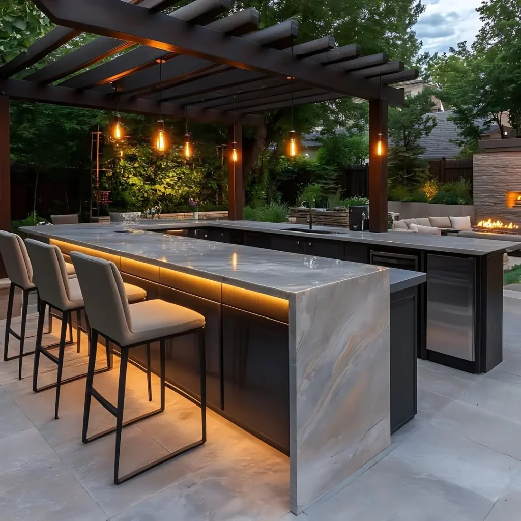 luxury covered outdoor kitchen design with lighting and bar seating