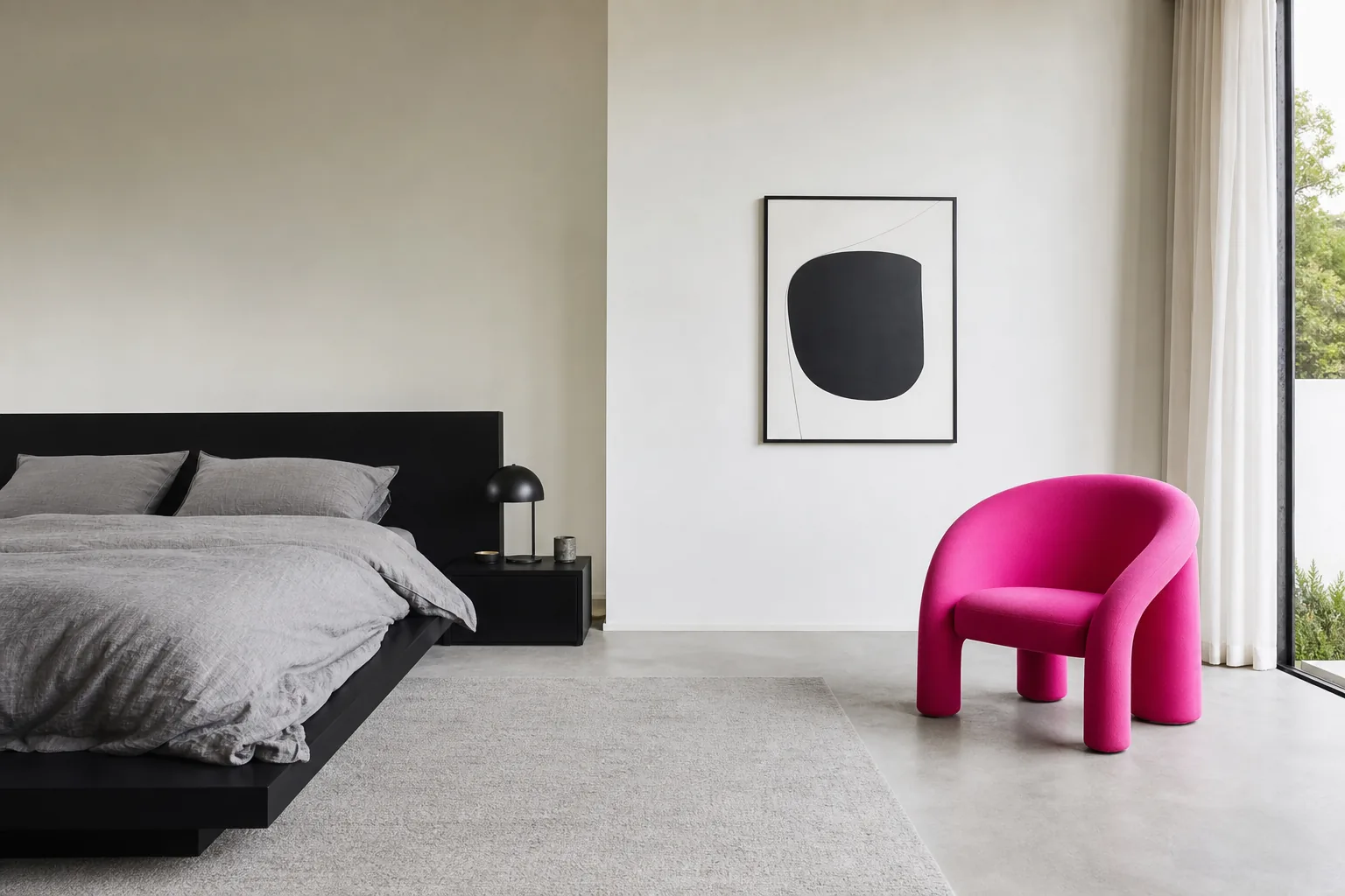 Minimal black and white bedroom with one electric pink chair as a bold statement accent